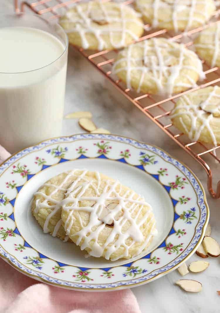 Almond cookies topped with two almond slivers and an almond glaze.