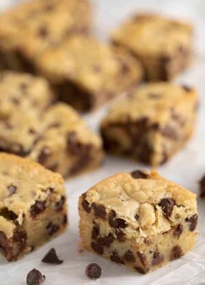 Chocolate chip cookie bars on a piece of parchment paper.