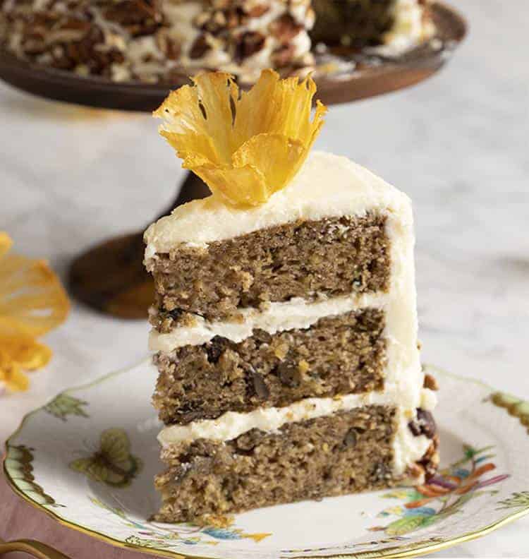 A piece of hummingbird cake topped with a pineapple flower