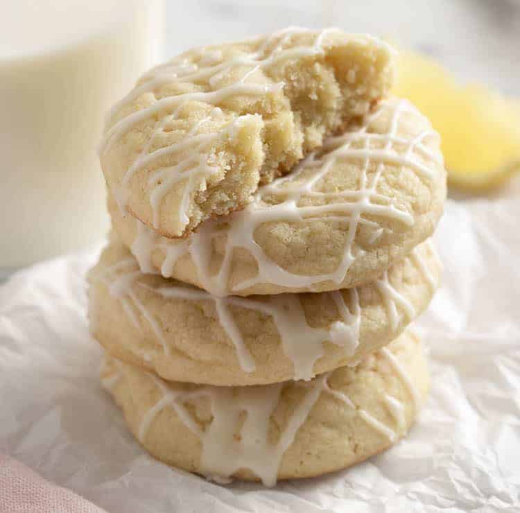  stack of lemon cookies with the top cut in half to show the cakey interior.