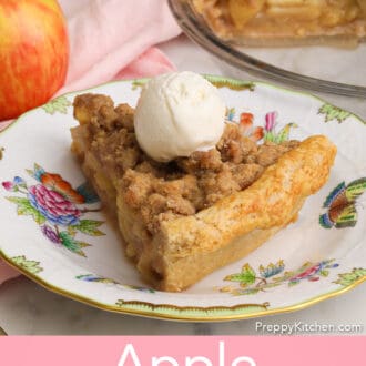 An apple crumble pie on a plate next to an apple.