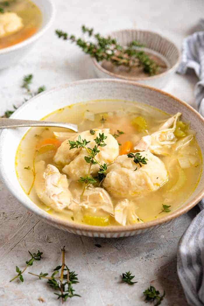 A close up of chicken and dumplings in a bowl