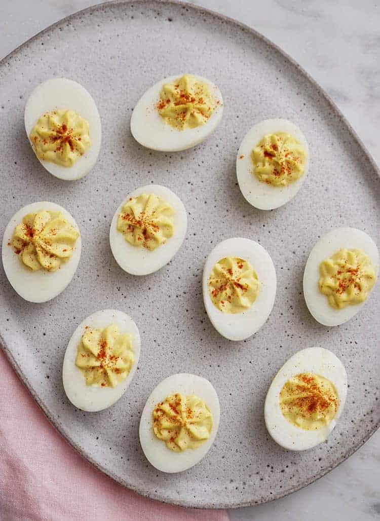A group of delicious deviled eggs on a platter.