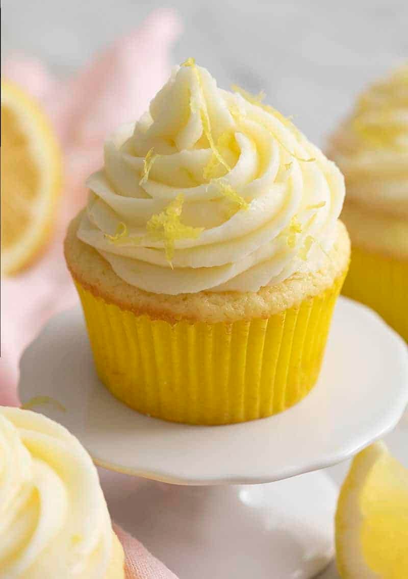 A lemon cupcake topped with a big swirl of lemon buttercream.
