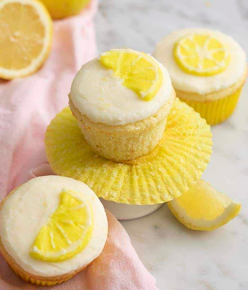 lemon cupcakes with buttercream lemon wedges piped on top.