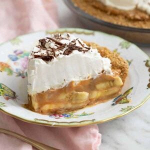 A slice of banoffee pie on a china plate