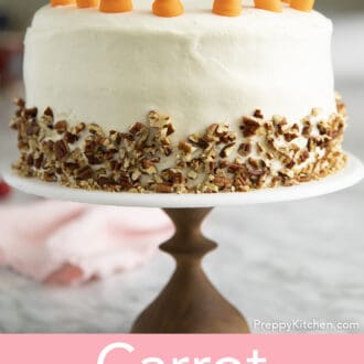 A side view of a carrot cake with buttercream carrots on top.