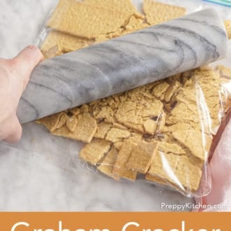 graham crackers in a bag being crushed with rolling pin