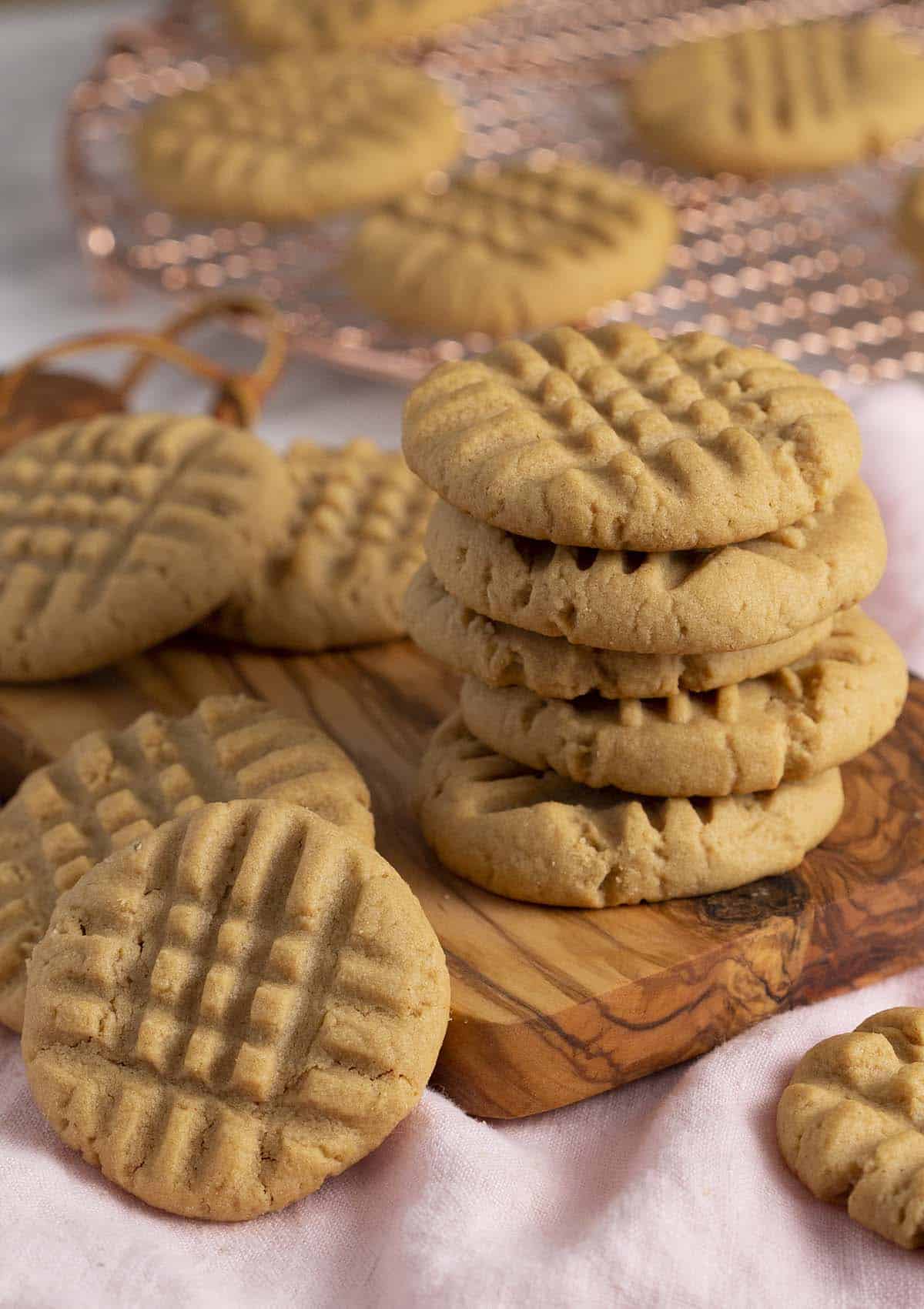 A stack of peanut butter cookies on a small wooden board