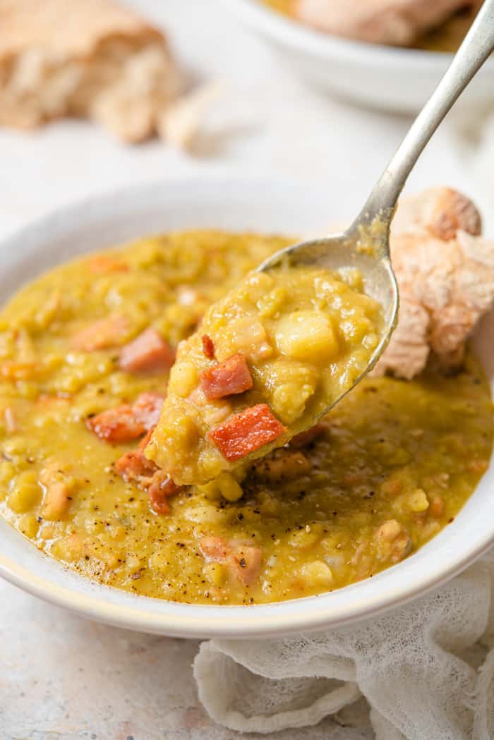 A close up of a spoonful of split pea soup