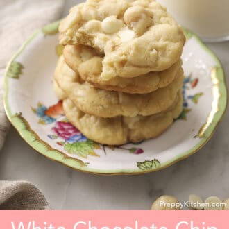 Three White chocolate chip macadamia nut cookies on a porcelain plate.