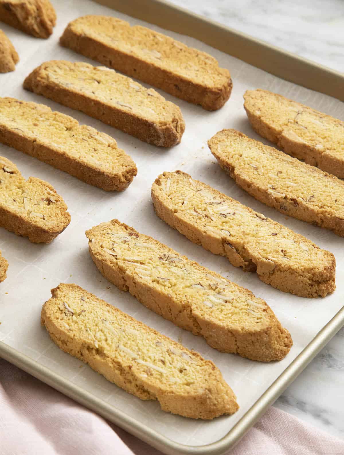 Biscotti cooling on a baking sheet.