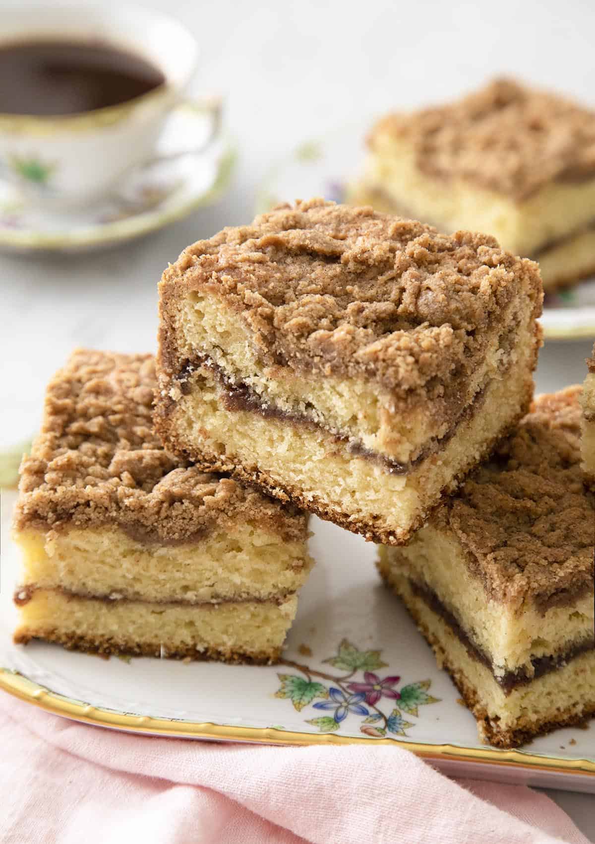 Pieces of coffee cake on a porcelain serving tray.