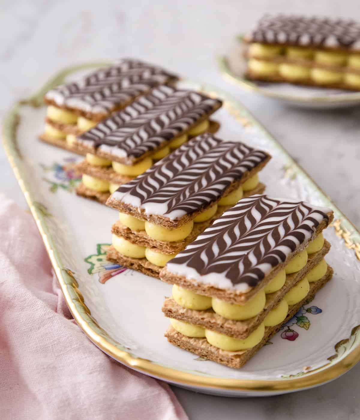 Four Mille Feuille on a serving plate.