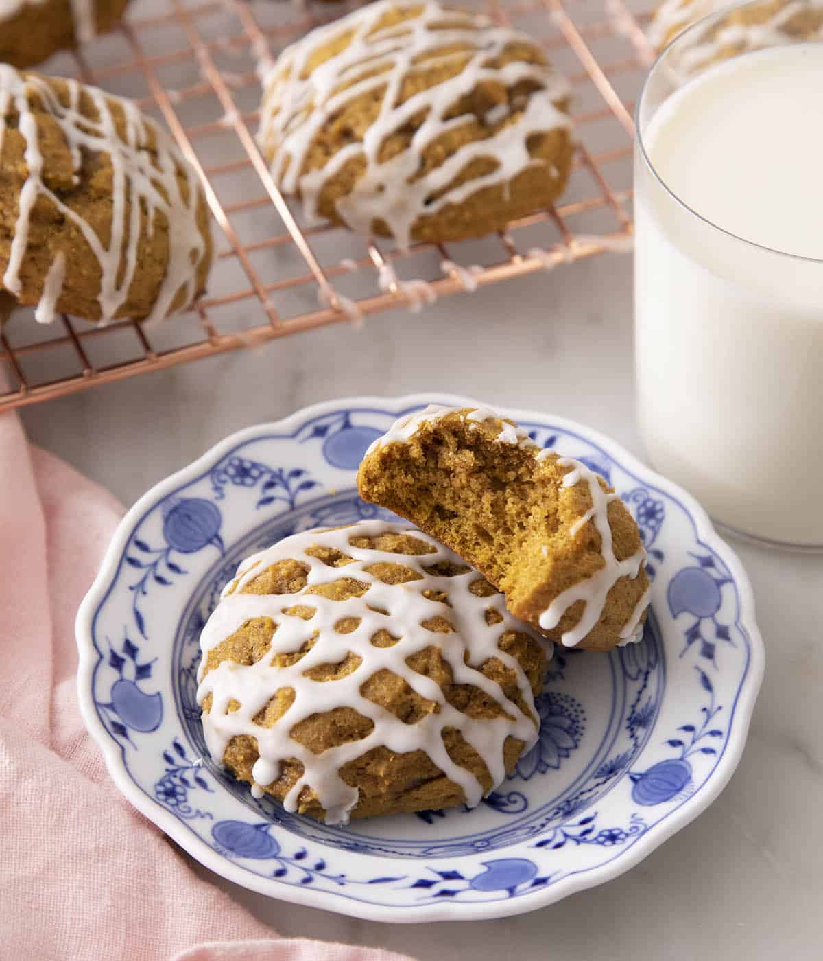 Pumpkin cookies drizzled with vanilla icing.