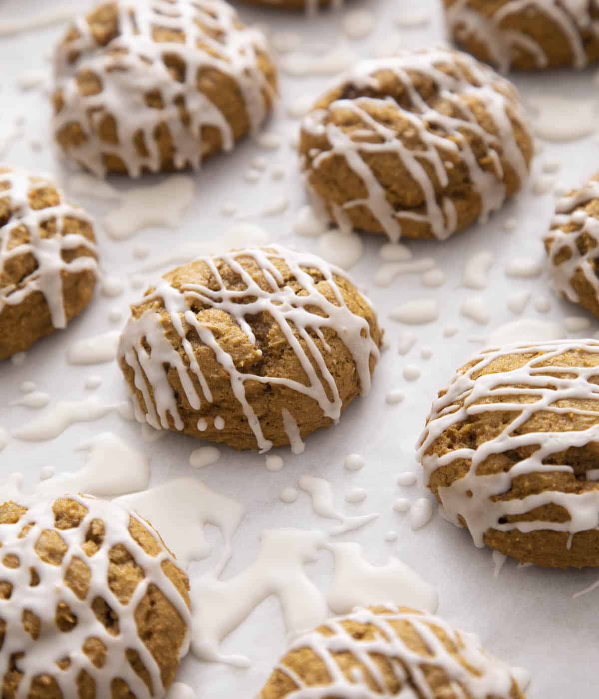 A group of pumpkin cookies on white paper.