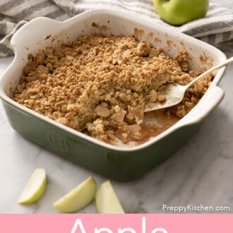 Pinterest graphic of a green baking dish of apple crisp with a serving spoon tucked into the crisp.