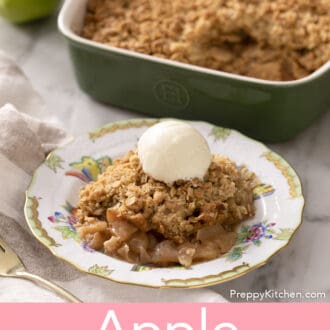 Pinterest graphic of a serving of apple crisp topped with ice cream on a marble counter. Green baking dish with more crisp in the background.