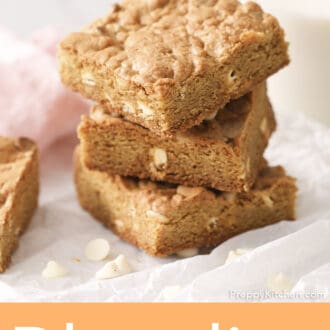 Pinterest graphic of three white chocolate blondies staked on a marble counter.