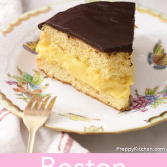 Boston cream pie with a bite taken out on a marble counter.