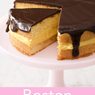A Boston Cream Pie on a pink cake stand.