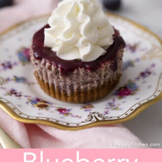 Whipped cream piped on top of a Mini Blueberry Cheesecake.