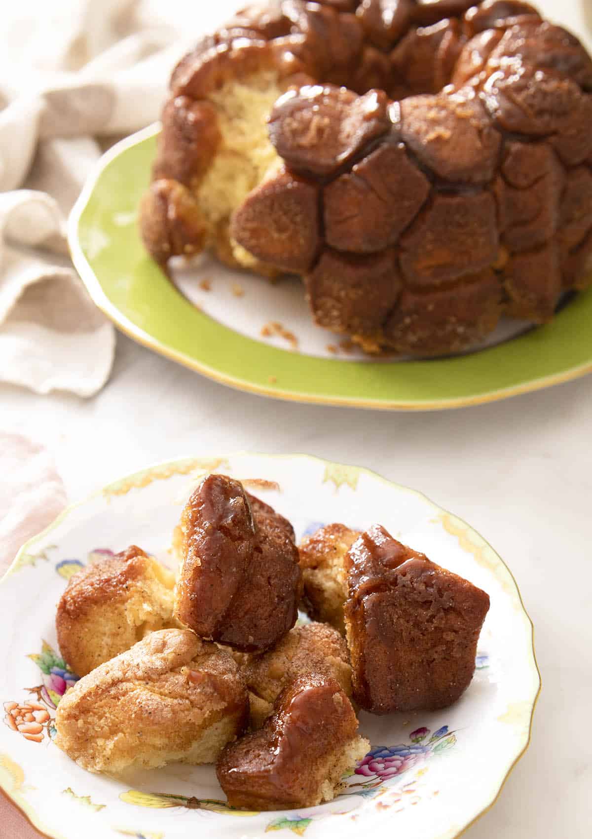 A plate of monkey bread pieces on a marble counter.
