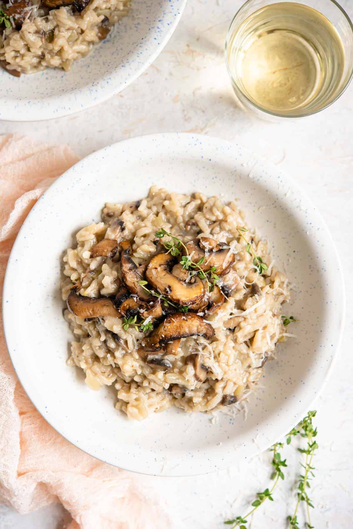 An overhead shot of mushroom risotto in a white bowl