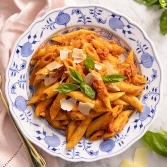 Penne alla vodka with basil and parmesan as garnish.