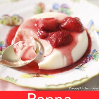 A partially eaten panna cotta with strwawberries.