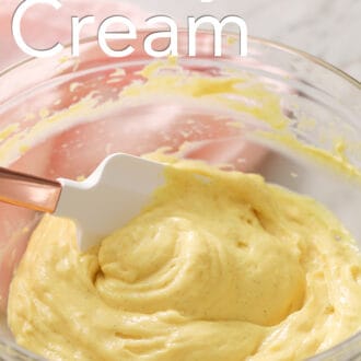 Pastry cream getting mixed in a glass bowl.