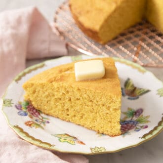Pinterest graphic of a triangle-shaped piece of cornbread on a porcelain plate.