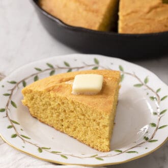Pinterest graphic of a piece of cornbread on a porcelain plate.