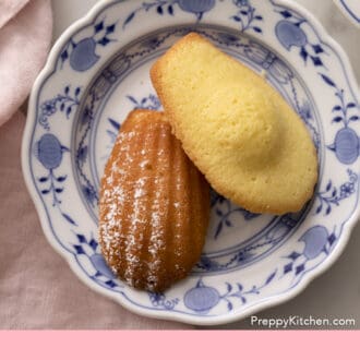 wo Madeleines on a blue and white plate.