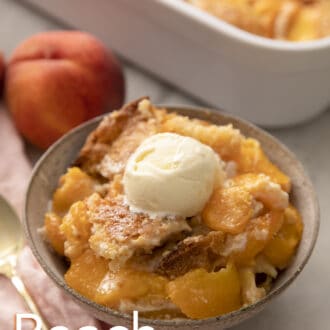 A grey bowl brimming with peach cobbler.