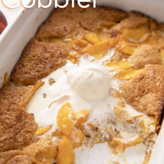 Vanilla ice cream melting in a dish of peach cobbler.