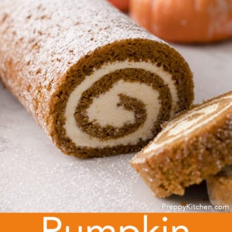A pumpkin roll cake with two pieces cut away.