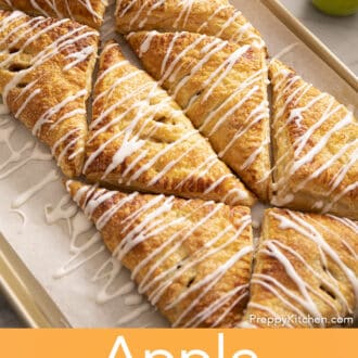 Pinterest graphic of glaze drizzled over multiple apple turnovers on a baking sheet.