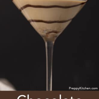 A chocolate martini with a swirl of chocolate syrup.