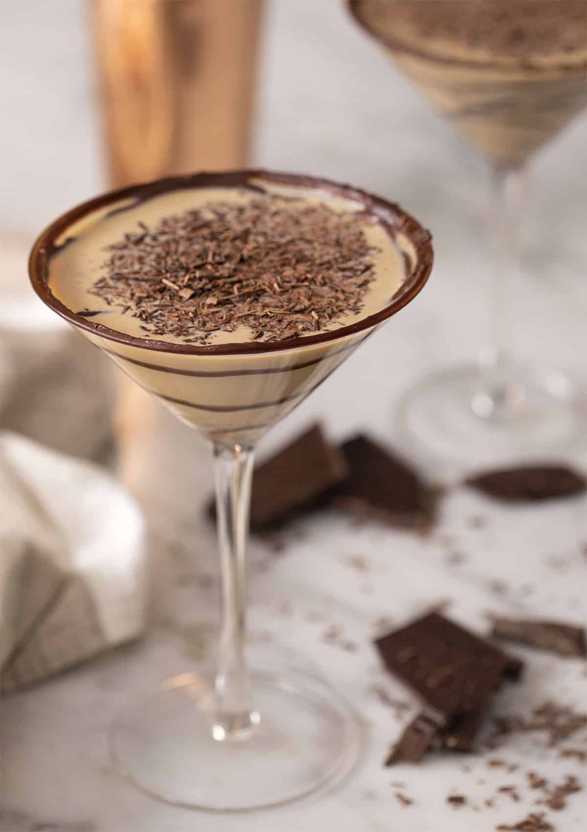 A chocolate martini topped with shaved chocolate.