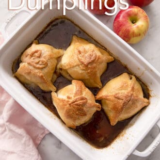 Four apple dumplings in a rectangular baking dish.