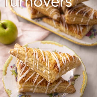 Pinterest graphic of two apple turnovers on a porcelain plate with a pile in the back.