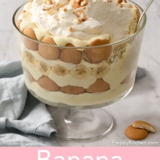 Banana pudding in a glass trifle dish with a spoon