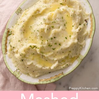 Pinterest graphic of mashed potatoes with melted butter and chopped herbs.