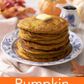 A stack of pumpkin pancakes on a blue and white plate next to a pumpkin.