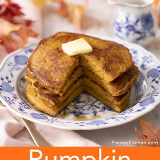 A cut stack of pumpkin pancakes on a blue and white plate.