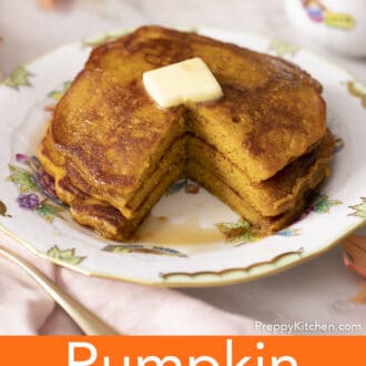 A cut stack of pumpkin pancakes on a porcelain plate.