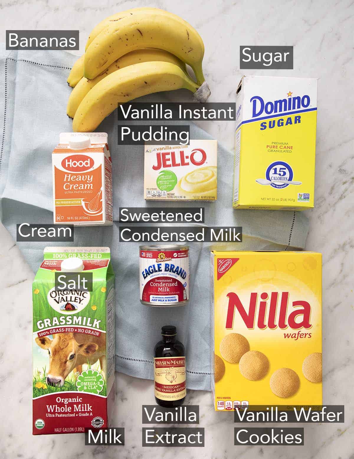 Ingredients for banana pudding on a marble counter.