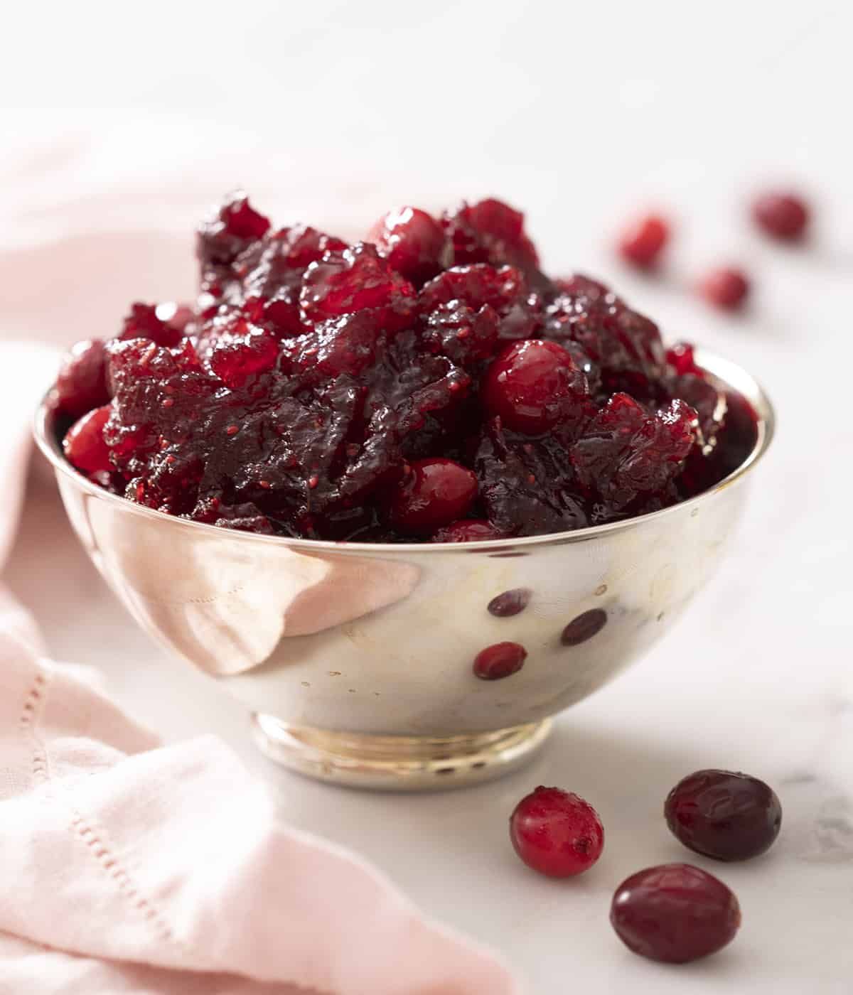 Homemade cranberry sauce in a silver bowl.
