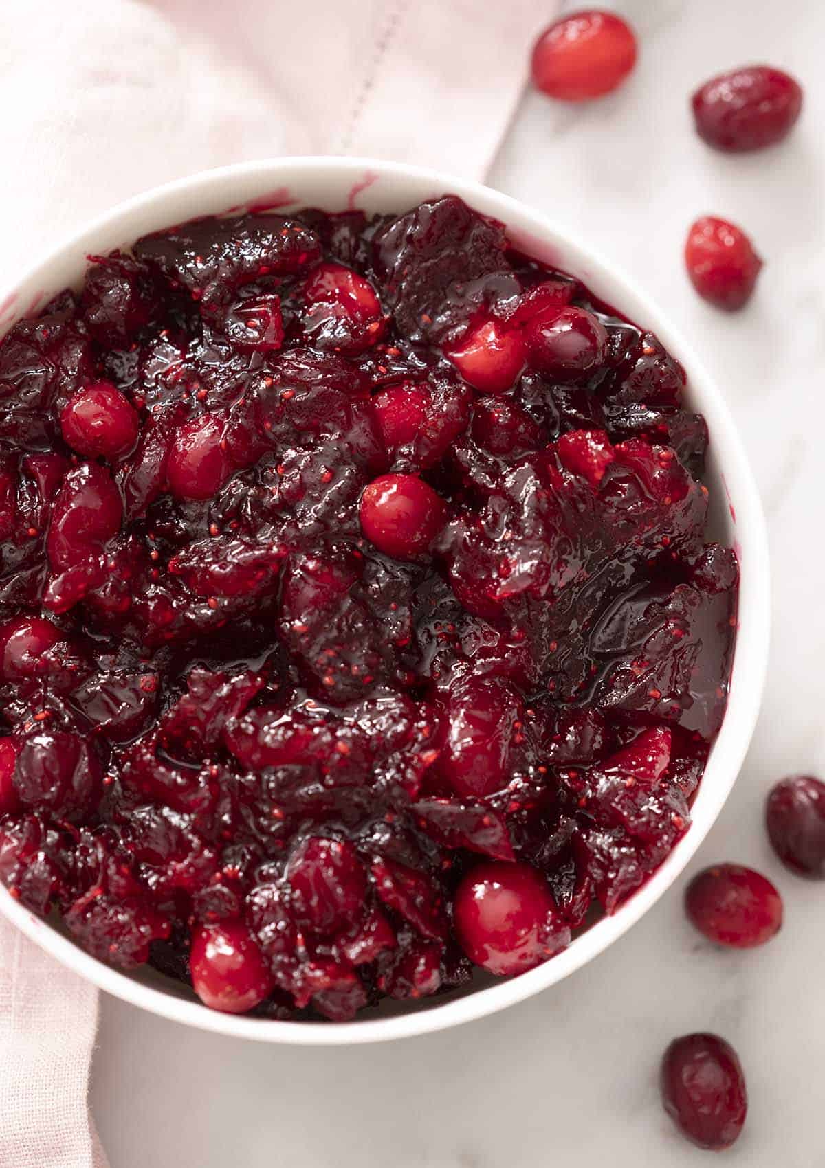 A white bowl filled with homemade cranberry sauce.